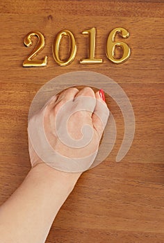 Hand and numbers 2016 on door - new year background