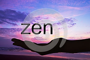 Hand offering the word zen,sunset background