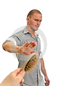 Hand offers hair brush to man