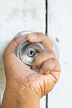 Hand on old door knobs