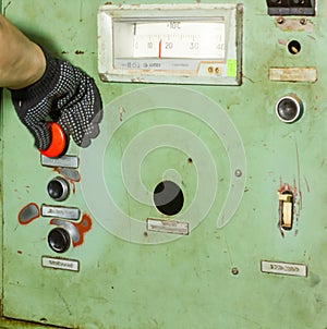 A hand on old electrical panel, old electrical switch