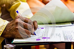 Hand of an old man writing important legal document