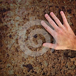 Hand on old rusty metal surface