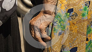 Hand of a old woman with crutch