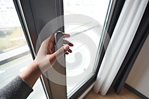 hand open black plastic pvc window at home