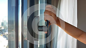 hand open gray plastic pvc window at home at early morning