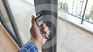 hand open gray plastic pvc window at home at early morning