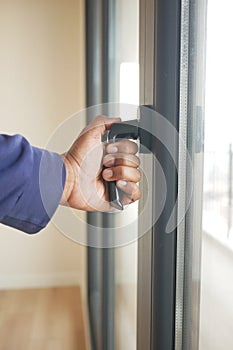 hand open gray plastic pvc window at home at early morning