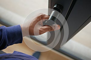 hand open gray plastic pvc window at home at early morning