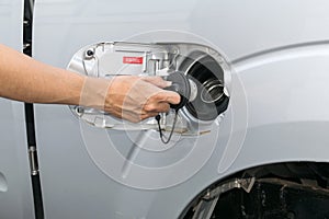 Hand opening the oil filler cap