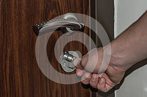 The hand opens the door with a key