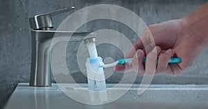 hand opens tap brings toothbrush washes. Highlighting cleanliness video captures essence cleanliness through act hygiene