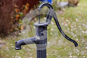 Hand-operated water pump with long handle