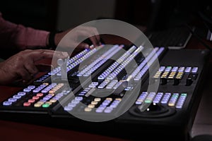 Hand operating video production switcher  television  audio visual  av  buttons