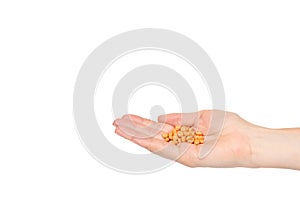 Hand with orange pills, medical care and help, chemical vitamins