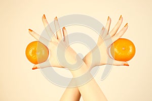 Hand with orange tangerine.