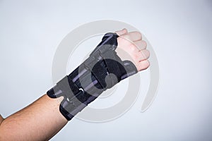 Hand in orthopedic orthosis on white backgroud