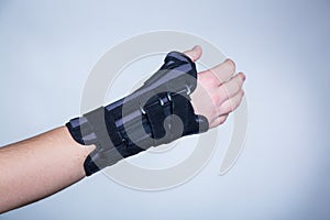 Hand in orthopedic orthosis on white backgroud