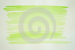 Hand painted aquarelle. Yellow-green brush strokes on a white background. Spring freshness watercolor background