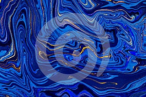 Hand painted background with mixed liquid blue and golden paints. Abstract fluid acrylic painting. Modern art. Marbled