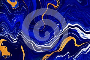 Hand painted background with mixed liquid blue and golden paints. Abstract fluid acrylic painting. Modern art. Marbled