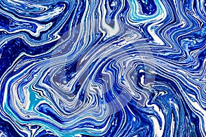 Hand painted background with mixed liquid blue, white, yellow paints. Abstract fluid acrylic painting. Applicable for