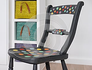 Hand painted chair, painted with Annie Sloan chalk paint, colourful baskets behind.