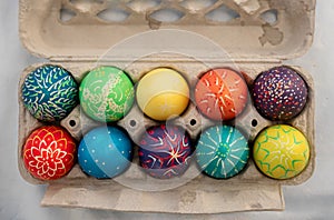 Hand painted colorful easter eggs in an egg carton