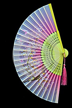 Hand painted decorative chinese bamboo folding fan on dark background.