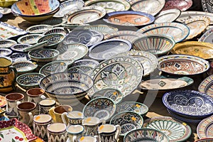 hand-painted dishes of a multitude of colors in a traditional ar