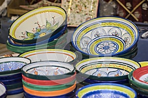 hand-painted dishes of a multitude of colors in a traditional ar