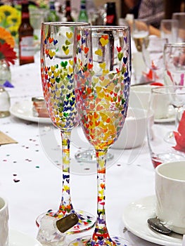 Hand painted hearts on wedding champagne glasses on wedding breakfast table