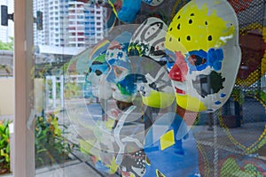 hand-painted masks behind glass display cases