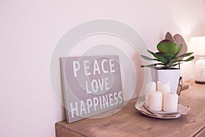 Hand-painted motivational wooden vintage board with text Peace, love, happiness.Motivational and inspirational life