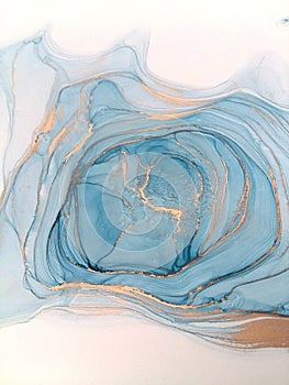 Luxury abstract fluid art painting background alcohol ink technique blue and gold. Swirls of shiny gold edges.