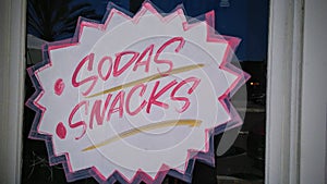 Hand painted sign saying sodas, snacks photo