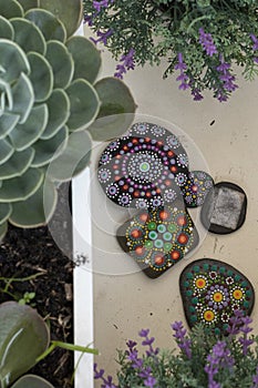 Hand-painted stones with mandalas as concentration and mindfulness exercise