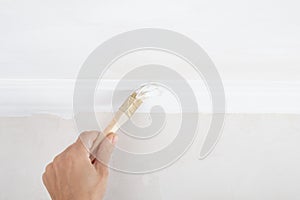 hand painting skirting boards white with a brush