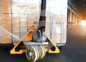 Hand pallet truck with shipment pallet goods. Cargo export.