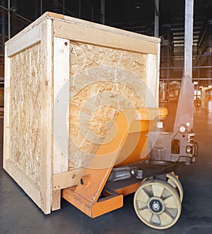 Hand pallet truck with wooden crate shipment at the warehouse. Cargo & shipping warehouse, Logistics and transportation