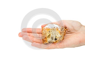 Hand palm showing partly eaten fritter or oliebol