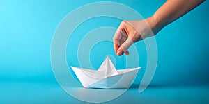Hand and paper boat ideas in blue background with dream and hope side communication. Business