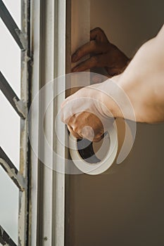 Hand pasting thef masking tape to the wall. Perfect sharp line between window and the walls. Home renovation ideas