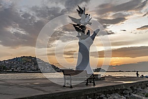 The hand of peace sculpture with doves on the waterfront in Kusadasi, Turkey