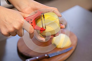 Hand peeling apple with peeler