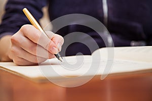 Hand with pen and music sheet