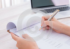 .Hand with pen over application form
