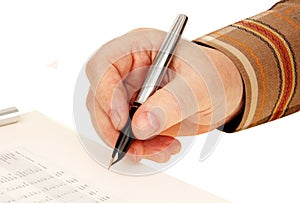 Hand with a pen. signature on the document.