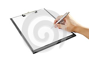 Hand with pen writing on clipboard