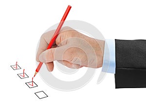 Hand with pencil and check boxes